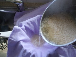 Pouring curds and whey into the colander